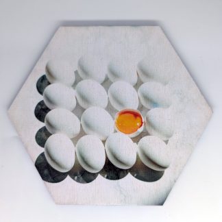 One in a million egg pop art hex wall tile with single cracked egg and orange yolk among white eggs, licensed art reproduction, UV printed on Baltic birch wood by HexWallTiles