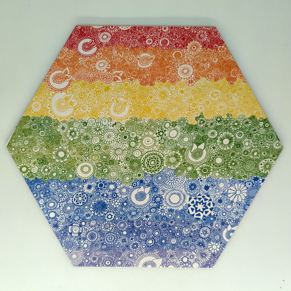 Rainbow mandala hex tile with hand-drawn floral pattern across six color bands